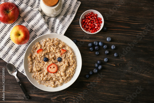 Wallpaper Mural Plate with creative oatmeal for children on dark wooden table Torontodigital.ca