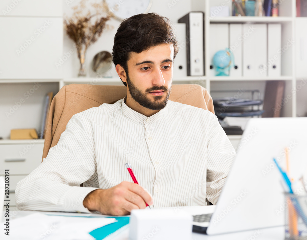 Fototapeta premium Office worker working at laptop
