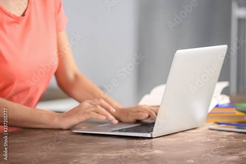 Young woman working with laptop at home © Pixel-Shot