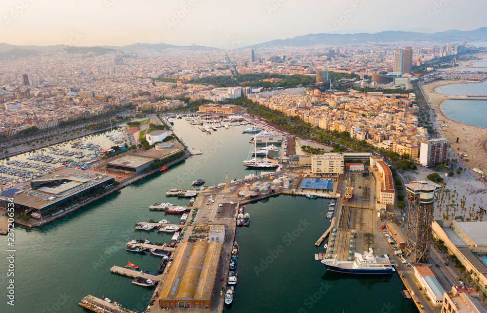 Aerial  view of old port in Barcelona city with of sailboats and yachts