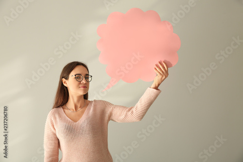 Young woman with blank spee...