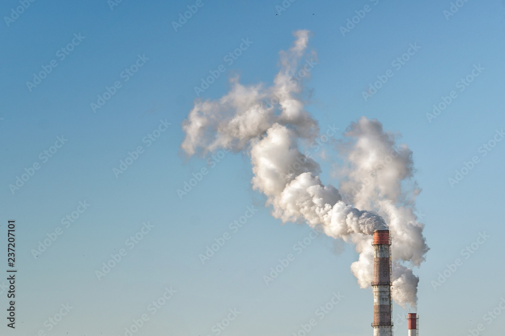 Smoke from industrial pipes in the blue sky, ecology-air pollution Smoke from industrial pipes in the blue sky, ecology-air pollution