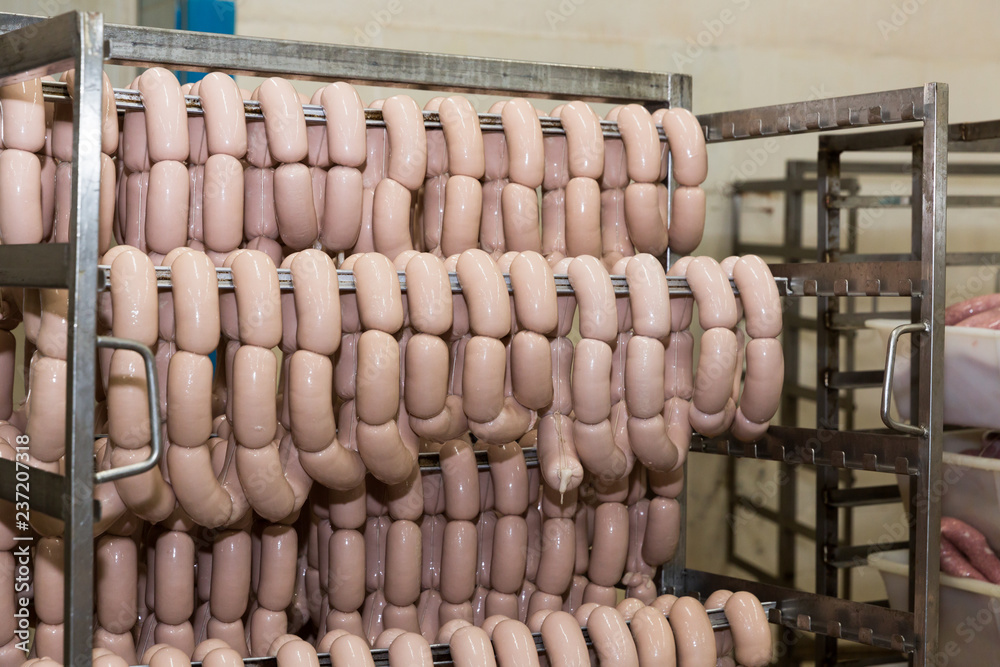 Sausages hanging on racks
