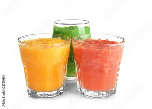 Glasses with tasty fruit smoothies on white background