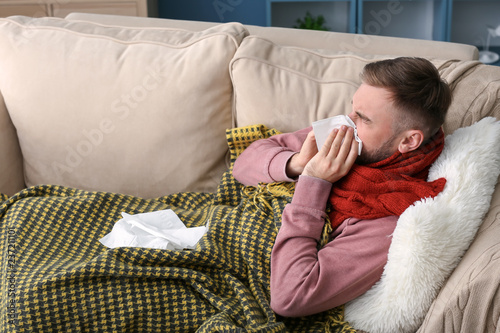 Young man ill with flu at home