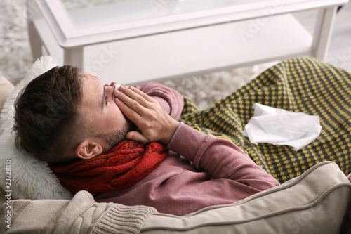 Young man ill with flu at home