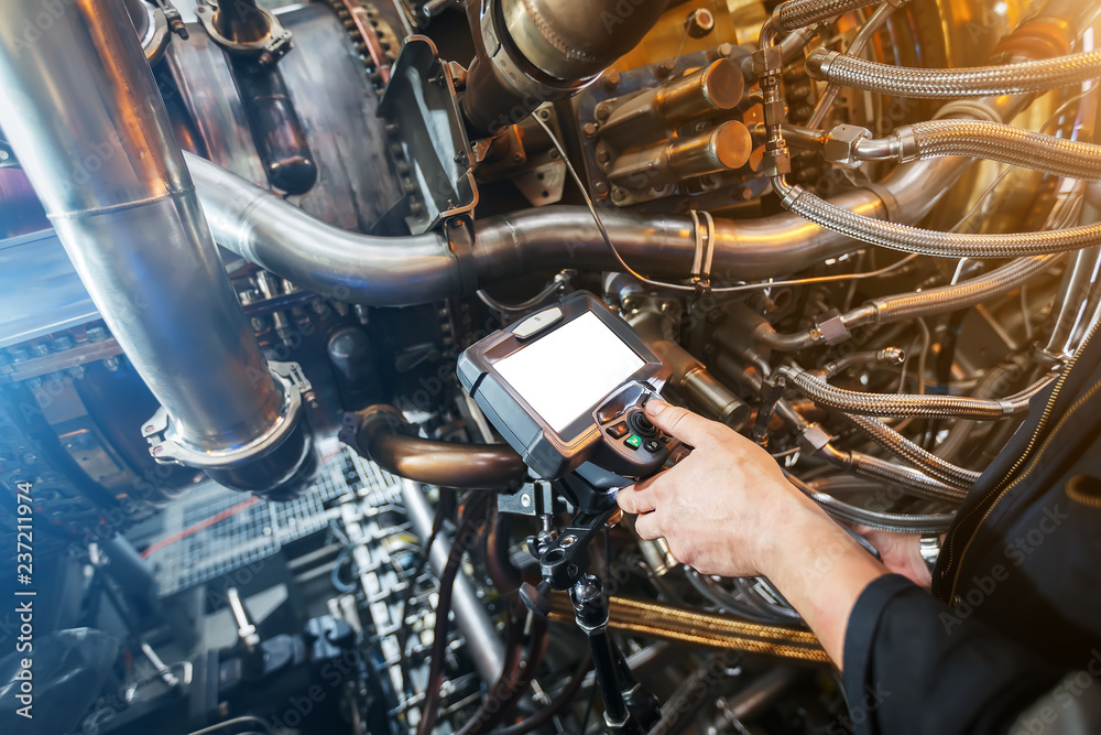 Inspection of a gas turbine engine using a Video Endoscope. Search for defects inside the turbine and shooting on video, photos using a measuring instrument. Inspection of a gas turbine engine using a Video Endoscope. Search for defects inside the turbine and shooting on video, photos using a measuring instrument.