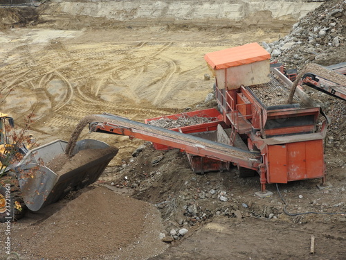 machine circular demolition concrete steel, stones, sand and grabber photo