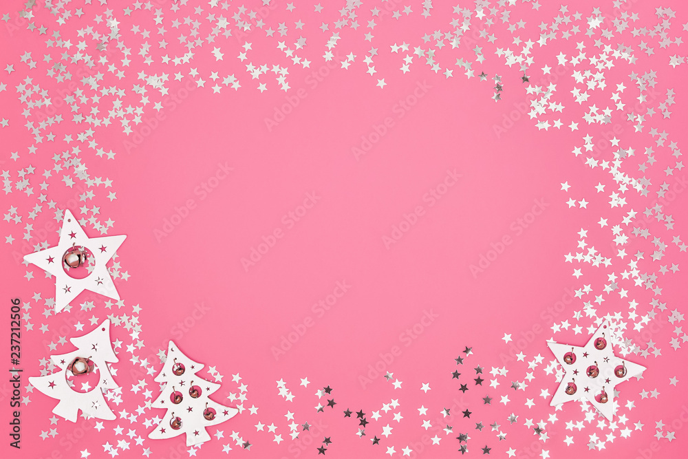 Christmas card. Christmas white and silver decorations on bright pink background. Copy space, top view. Flat lay