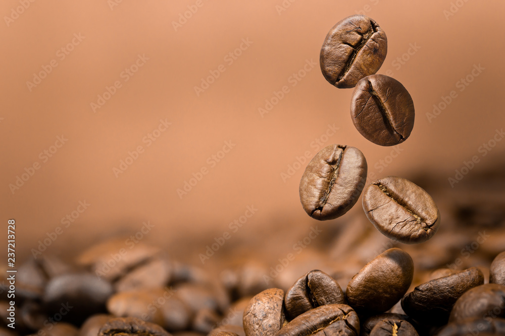 Fototapeta premium Coffee beans falling on pile