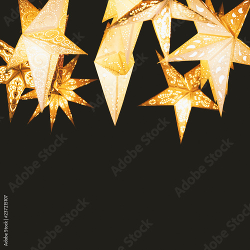 Billede på lærred star-shaped paper lantern against night sky - star lampions on black background