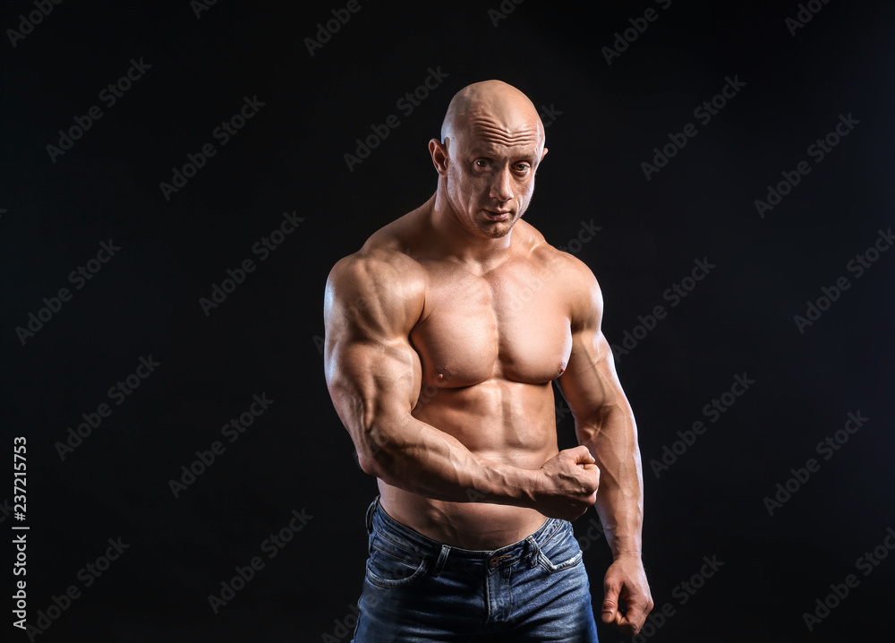 Fototapeta premium Muscular bodybuilder on dark background