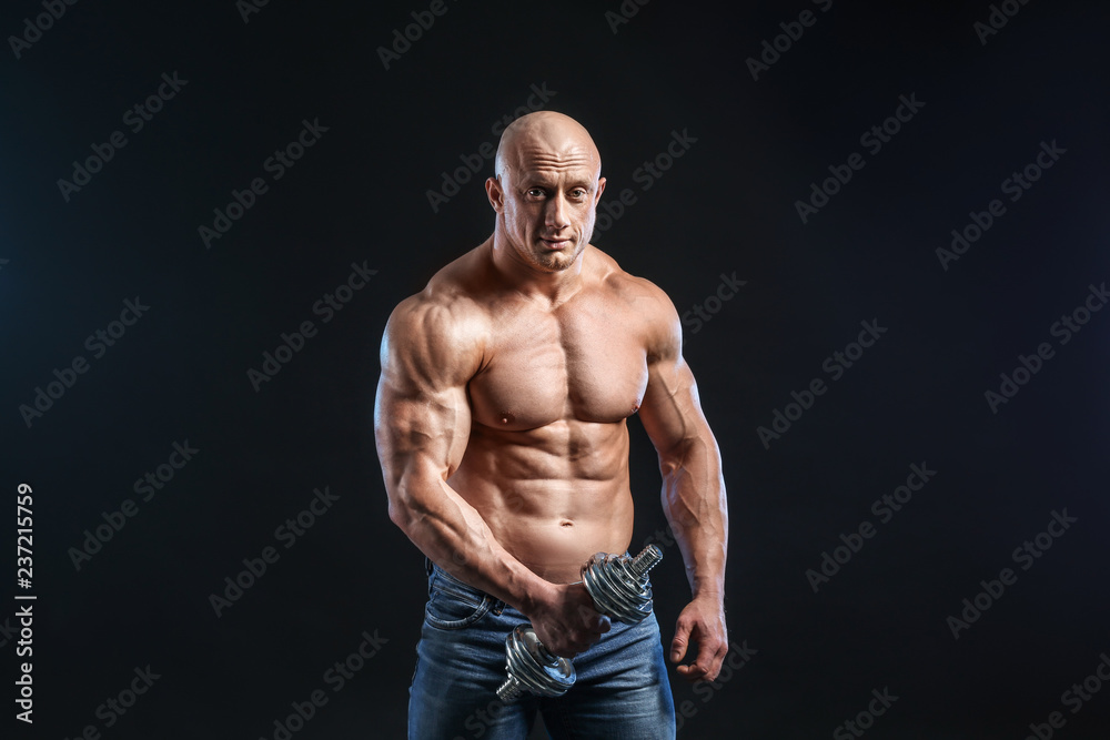Fototapeta premium Muscular bodybuilder on dark background