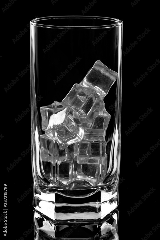 glass with ice cubes on black background glass with ice cubes on black background