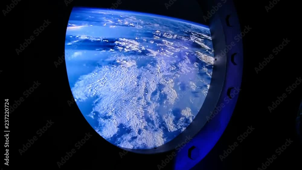 View of the Earth through the porthole of spaceship. International space station View of the Earth through the porthole of spaceship. International space station