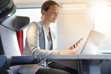 Businesswoman on her cellphone on a train