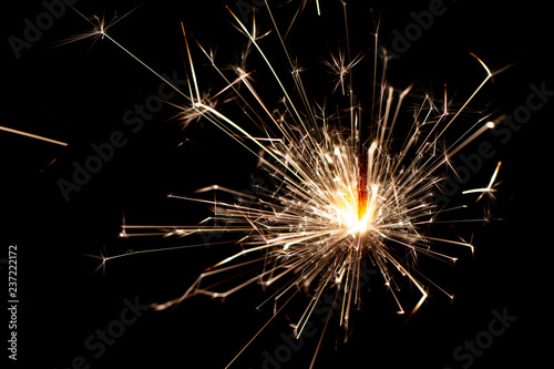 Christmas sparkler isolated on black background. Bengal fire