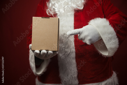 Father Santa Claus holding in hands surprise present gift box seasonal tradition background. Merry Christmas and Happy New Year amazing excitement time