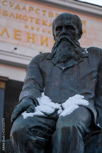 Moscow, Russia - December, 1, 2018:  The Russian state library of Lenin and monument to Fedor Dostoyevsky at an entrance