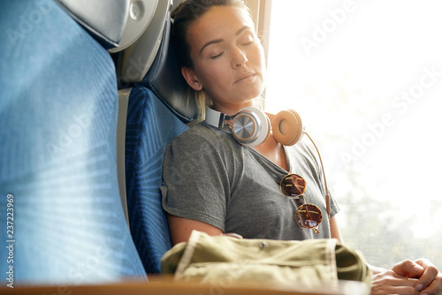 Young woman sleeping peacefully on train