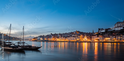 view of the city of poto at night with classic rabelo boat on the river © Michele