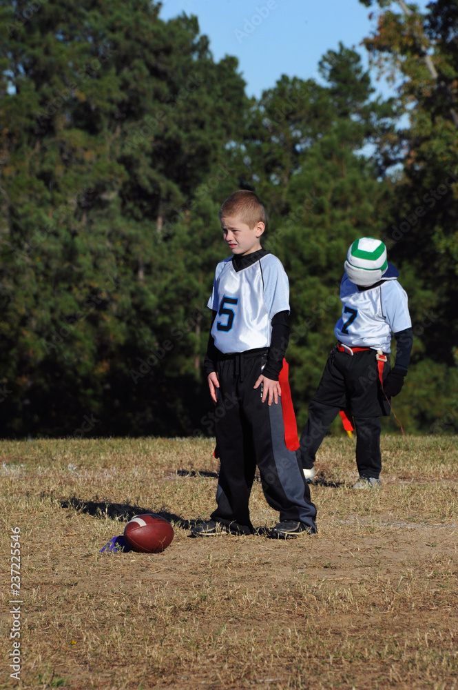 Fototapeta premium Boy Plays Quarterback in Flag Flootball