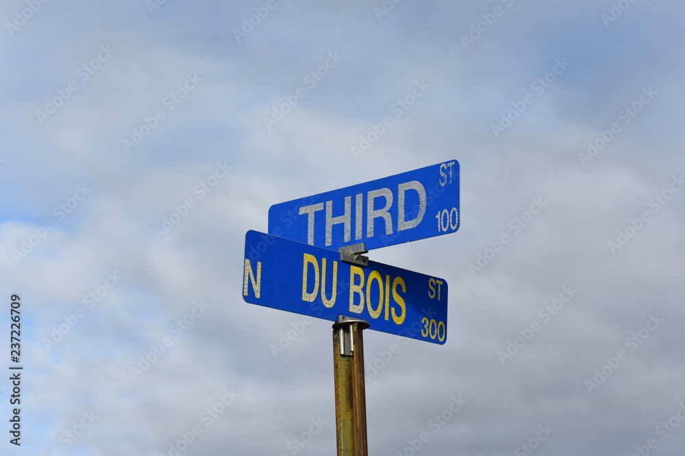 blue street sign intersection blue sky blue street sign intersection blue sky