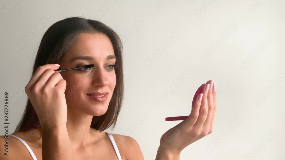 Mascara. Long lashes closeup. Beautiful woman applying mascara on her eyes Mascara. Long lashes closeup. Beautiful woman applying mascara on her eyes