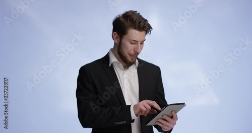 Young and handsome buisnessman working on a tablet photo