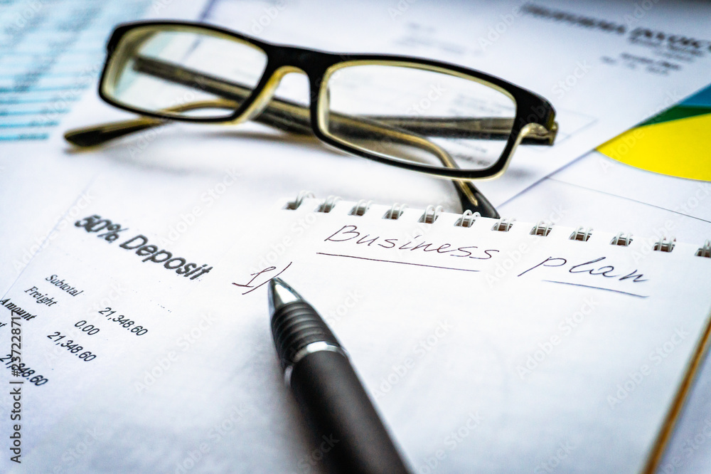 Business plan and business chart with glasses and pan Business plan and business chart with glasses and pan