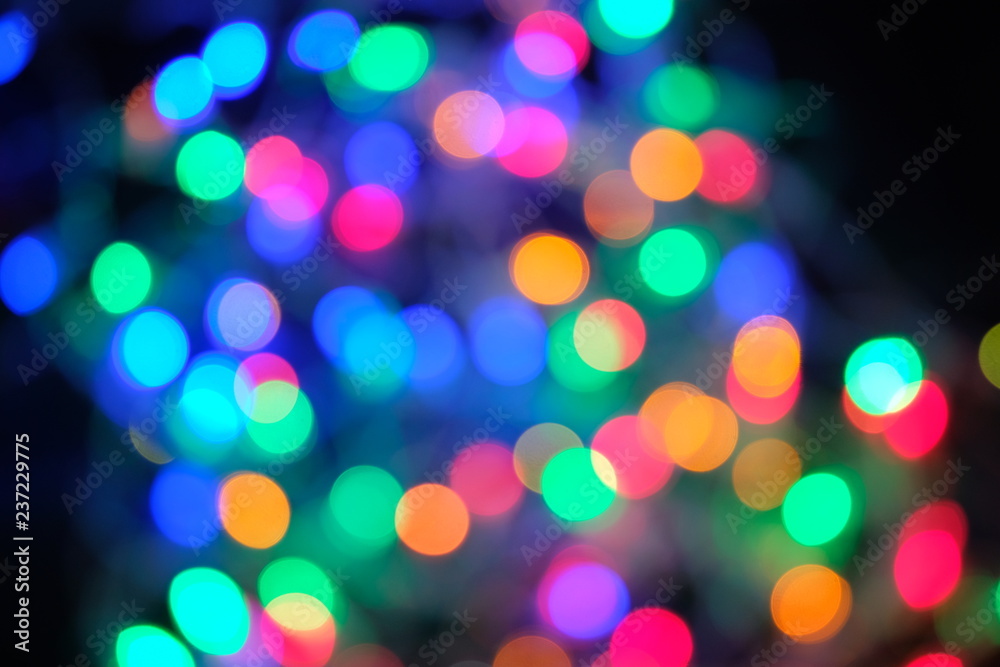 Defocused abstract multicolored bokeh lights background.Magic explosion star with particles