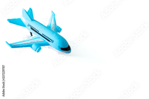 Blue toy airplane on white background with copy space, travel, journey and flying concept