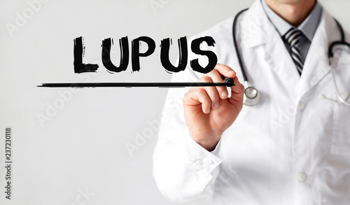 Doctor writing word Lupus with marker, Medical concept