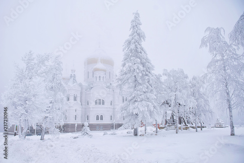 Orthodox church in winter, Russian Federation. Belogorsky Monastery. White background.  photo