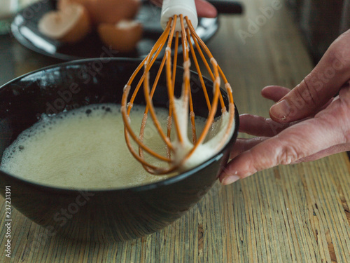whisk and eggs in bowl