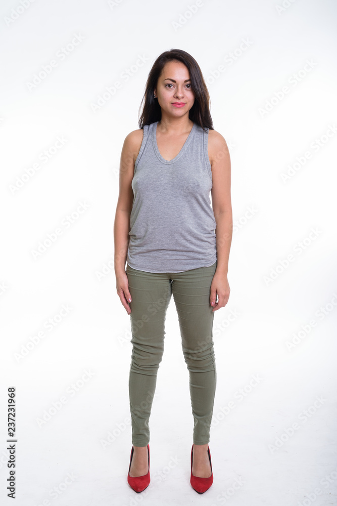Full body shot of beautiful woman standing against white backgro Full body shot of beautiful woman standing against white backgro