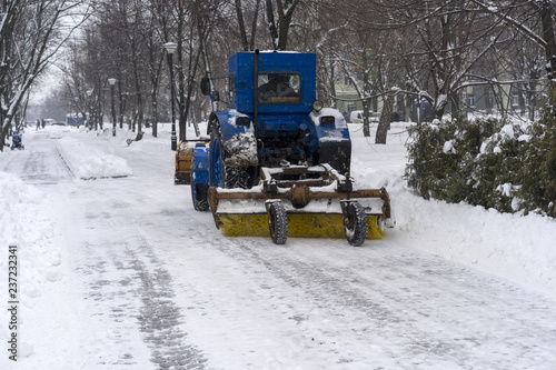 covered with snow, snow removal equipment on the streets to clean