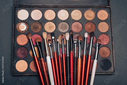 makeup brush set and professional eye shadow palette to make feminine beauty