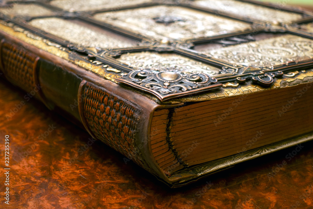 Antique book, with brass clasps on the old table. Medieval period of fantasy  and religious concept. Stock Photo | Adobe Stock