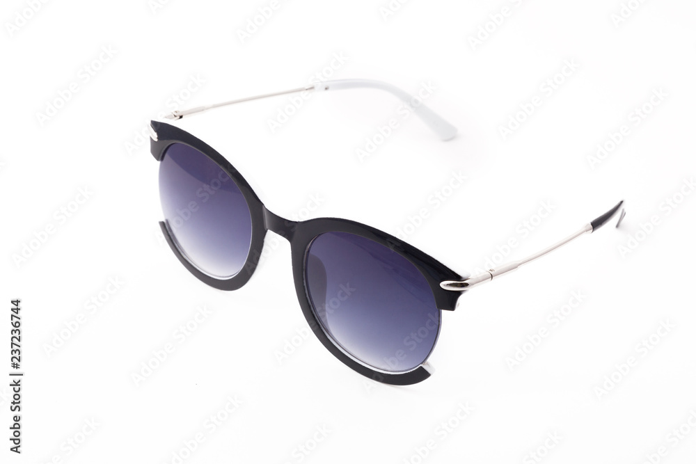 Women's sunglasses with purple tint stand frontally isolated on a white background with a shadow. Glasses rotated to the left. Women's sunglasses with purple tint stand frontally isolated on a white background with a shadow. Glasses rotated to the left.