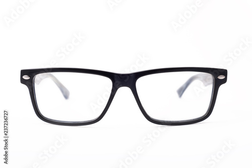 Rectangular black-rimmed glasses are located frontally on a white background. Isolated.