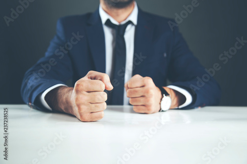 man fists on table photo