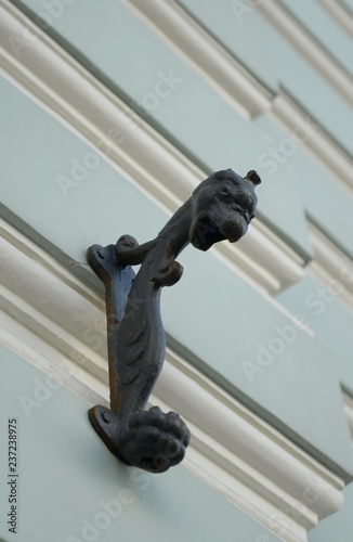 Gargoyles on the wall of an old building on Rozhdestvenka Street in Moscow photo