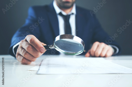 man hand magnifier and document