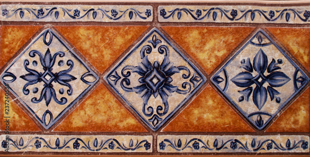 Detail of the traditional tiles from facade of old house. Decorative tiles.Valencian traditional tiles. Floral ornament. Detail of the traditional tiles from facade of old house. Decorative tiles.Valencian traditional tiles. Floral ornament.