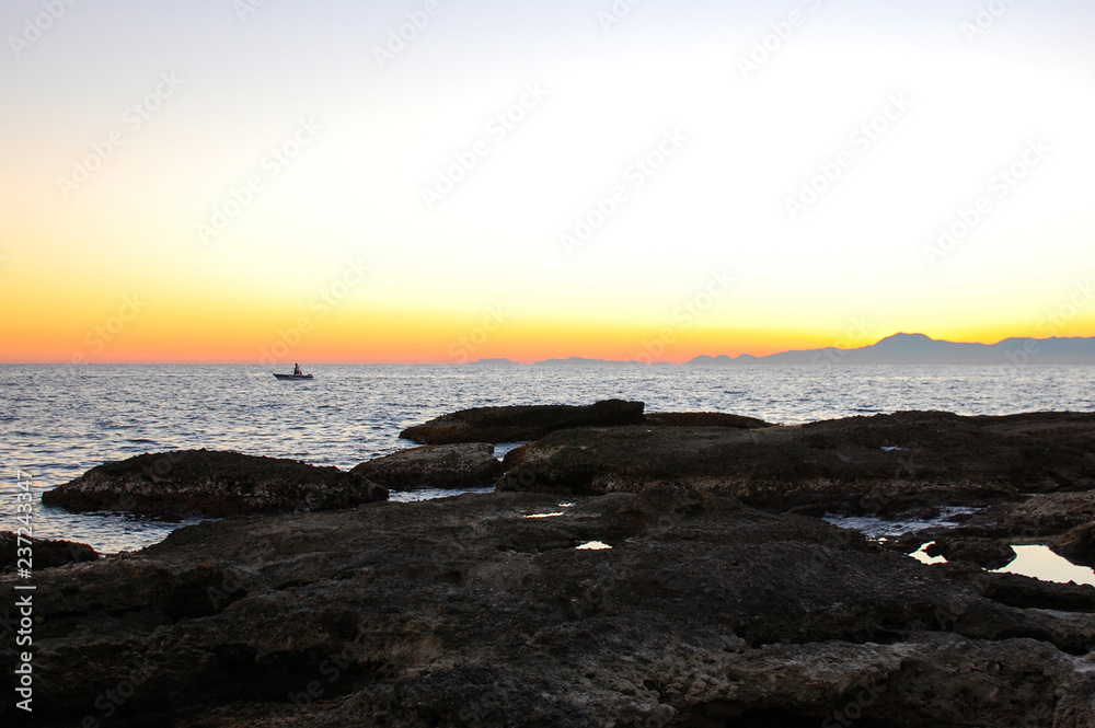 Fototapeta premium Beautiful neutral background. Sea with waves at sunset on a spring day.
