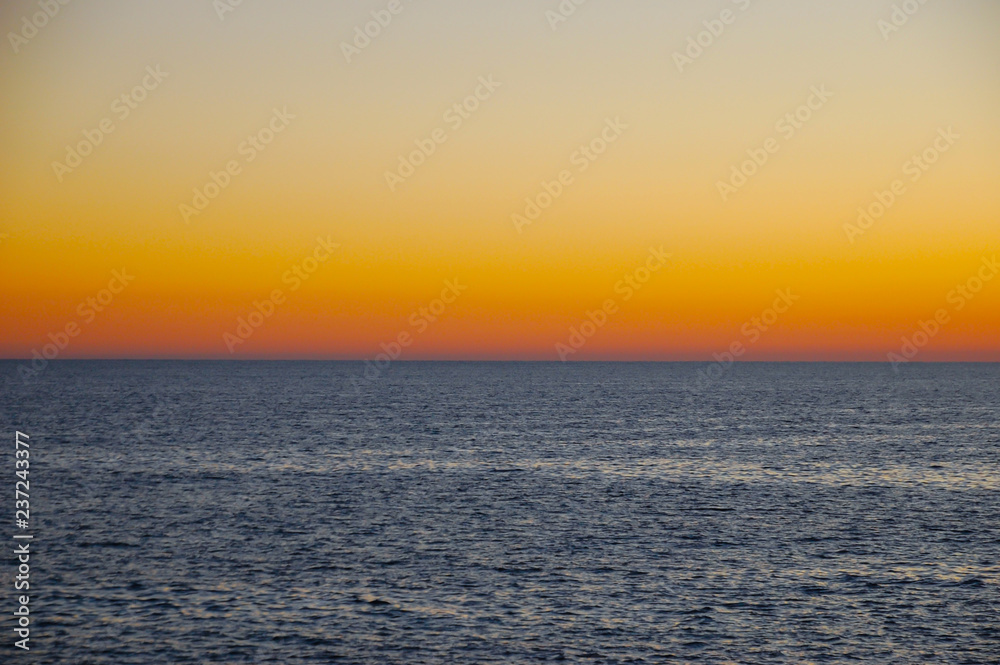 Beautiful neutral background. Sea with waves at sunset on a spring day.