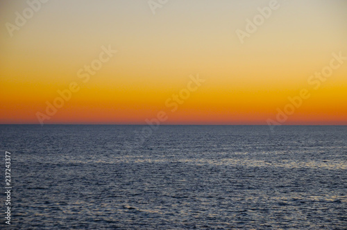 Beautiful neutral background. Sea with waves at sunset on a spring day.
