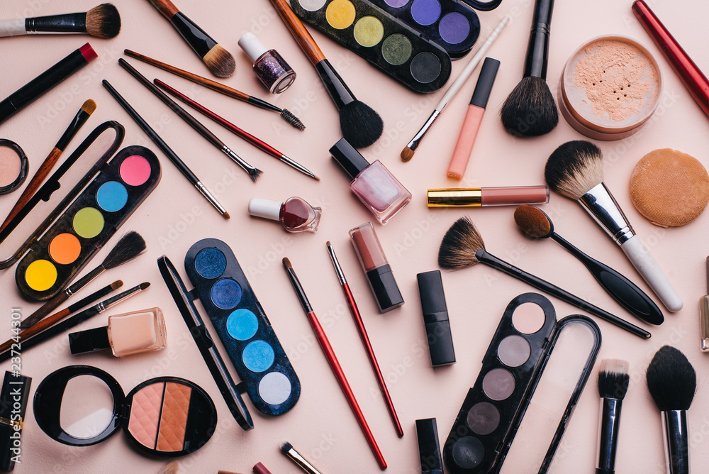 Women's cosmetics and makeup set on pink background. Top view, flat lay collage Women's cosmetics and makeup set on pink background. Top view, flat lay collage