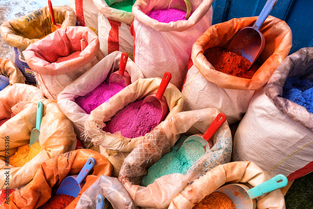 Bright moroccan dry paint in open sacks, dyes powdered pigments, paint of different typical colors for sale. Blue town Chefchaouen, Morocco